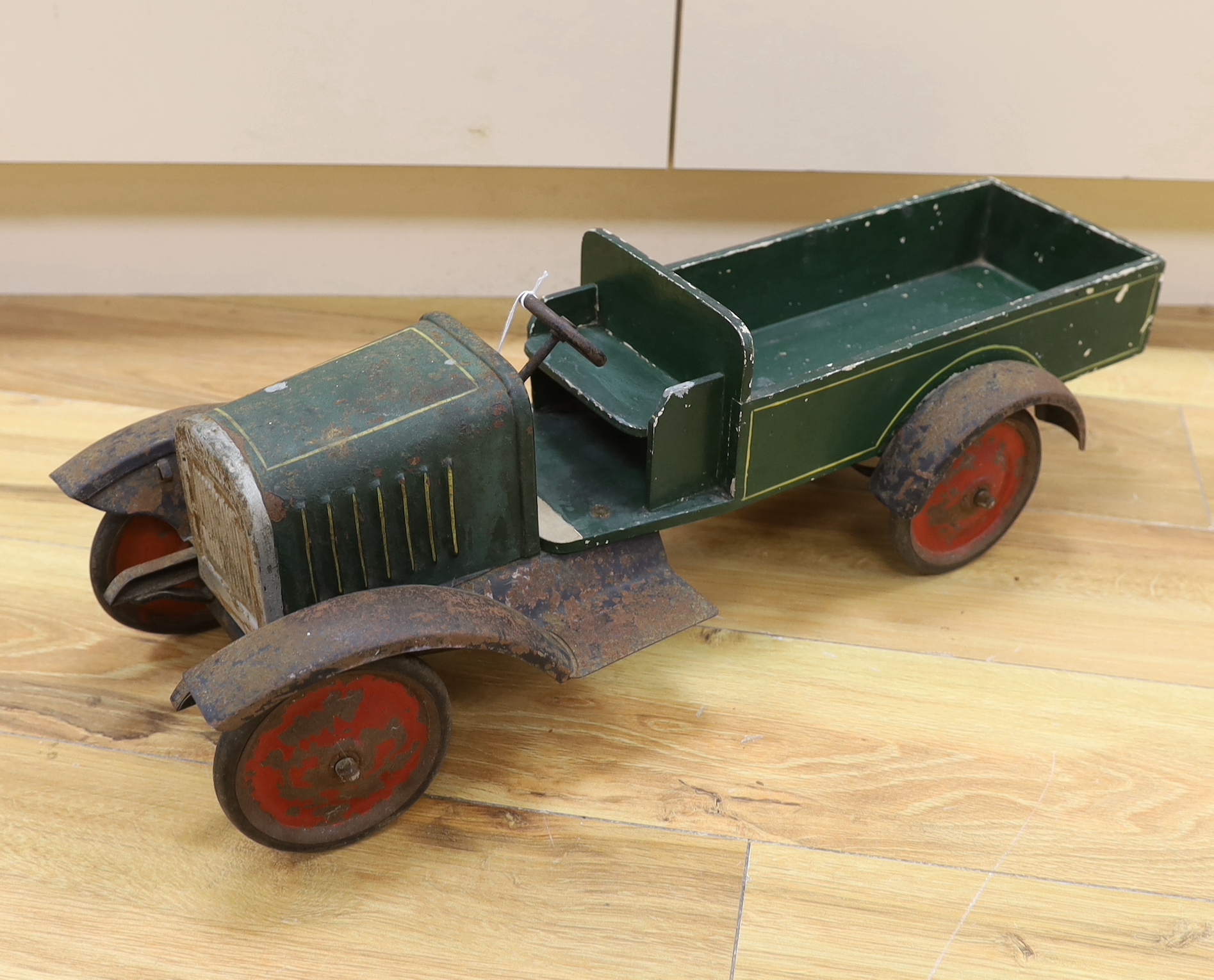 A large 1920s style tinplate and wood truck, length 62.5cm